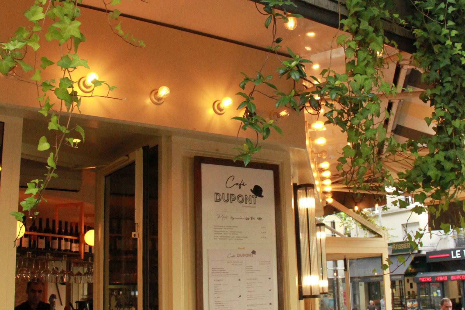 The dining room under the ivy and string lights